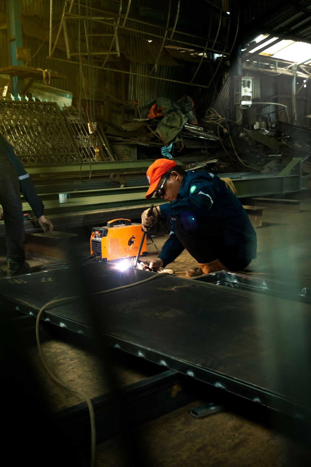A welder at work in a metal workshop